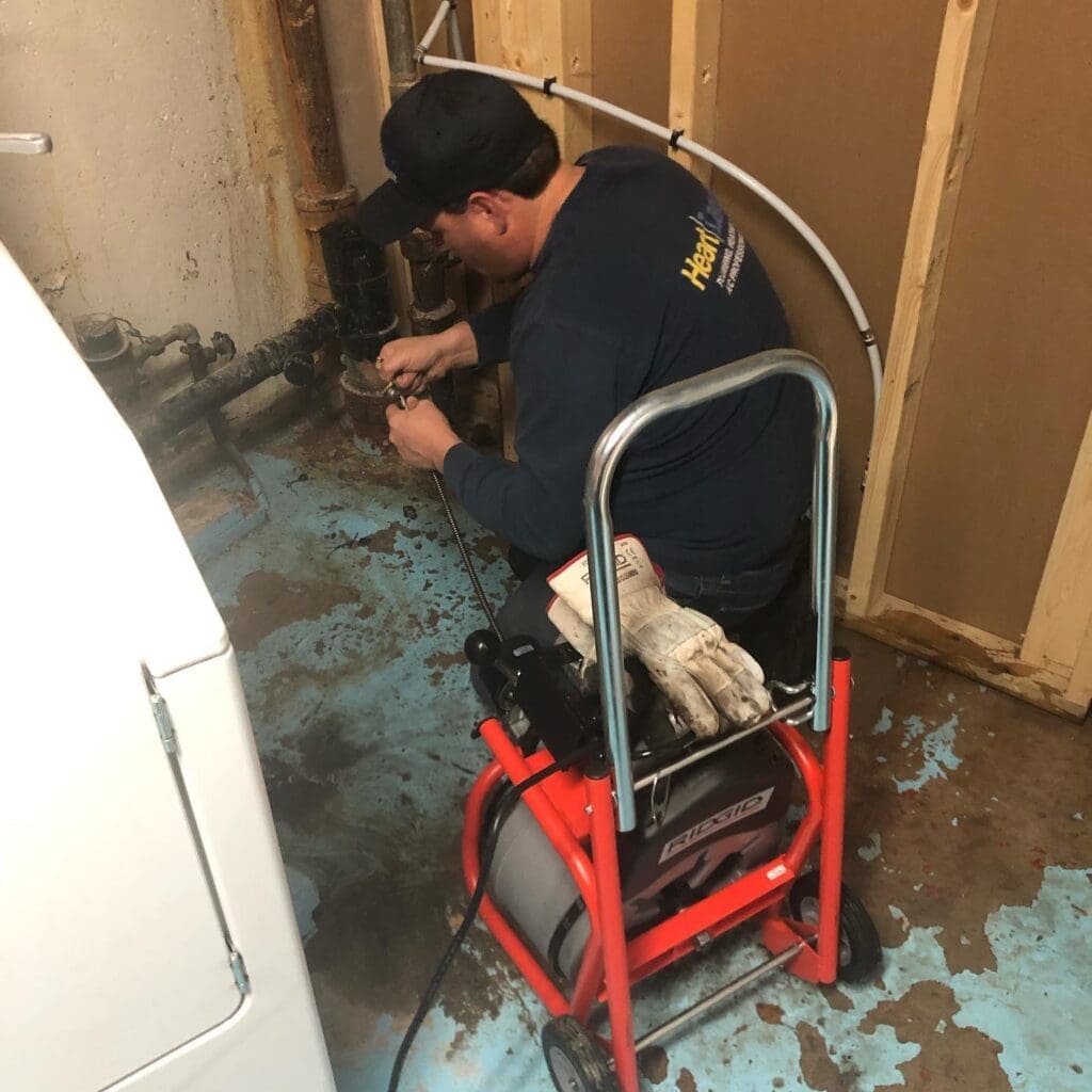 Drain cleaning and clearing a main drain in St Albert plumbing emergency Jaxon the owner of Heartland Plumbing and heating Ltd, cleaning a drain and clearing a main drain in st albert emergency call