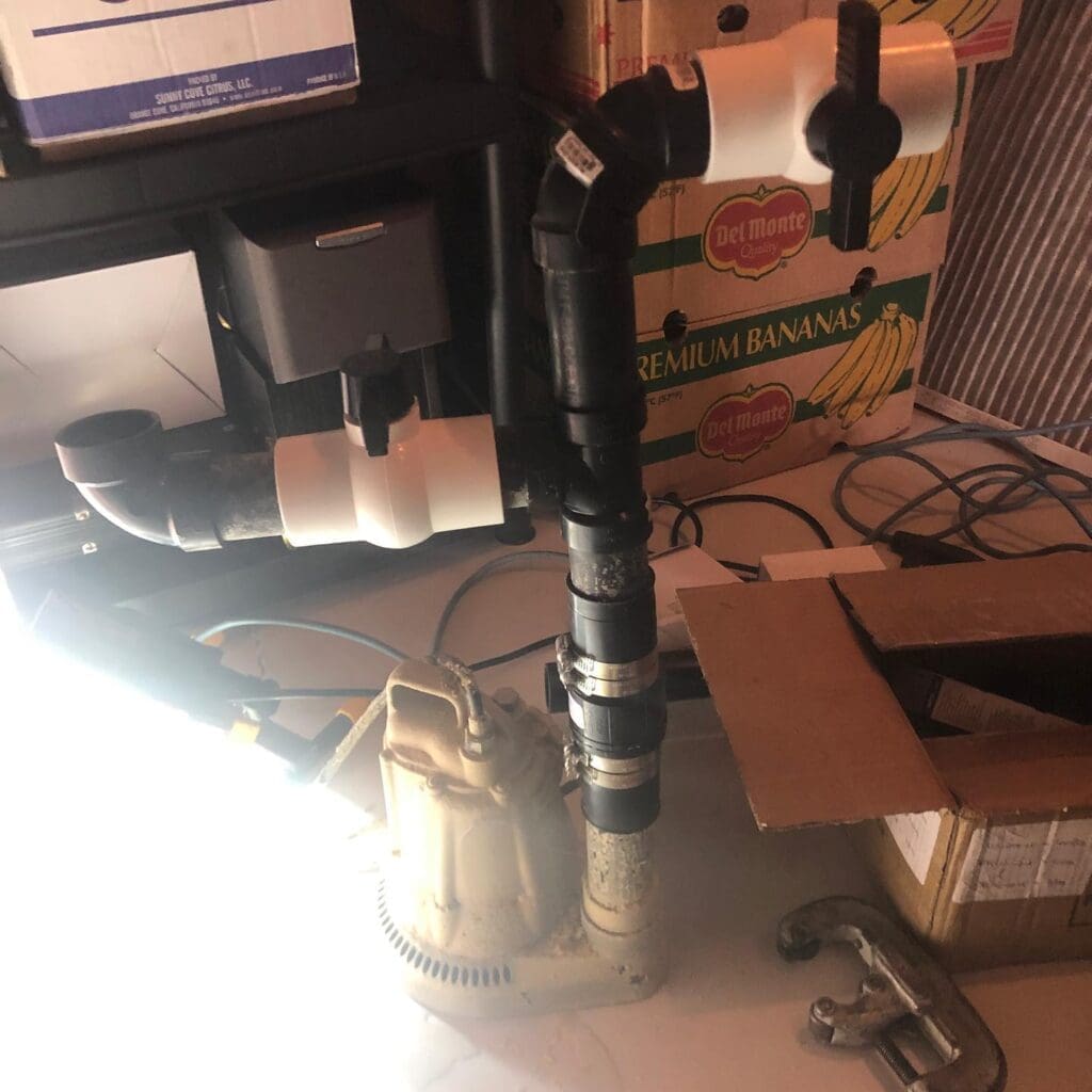 Sump pump install in Fort sask plumbing emergency call sump pump install in progress in fort sask plumbers from Heartland on emergency call