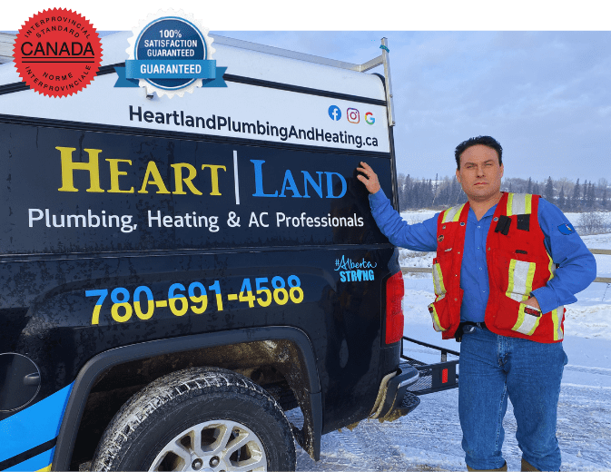 owner-of-heartland-plumbing-and-heating-ltd-michael-kuchmak-known-as-jaxon owner of heartland plumbing and heating ltd by his work truck, red seal badge and 100% satisfaction guarantee badge